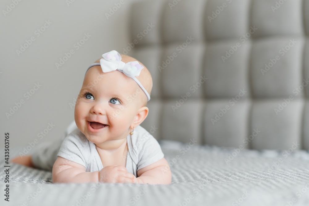 A Baby girl in white bedding at home look nice A Baby girl in white bedding at home look nice