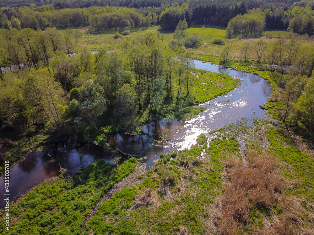 Flight over a small river on a sunny spring day. Flight over a small river on a sunny spring day.