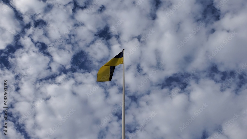 Ukrainian flag waves in wind on cloudscape background at sunny day. Yellow and blue flag of Ukraine country. Fluffy white cumulus clouds in blue sky Ukrainian flag waves in wind on cloudscape background at sunny day. Yellow and blue flag of Ukraine country. Fluffy white cumulus clouds in blue sky