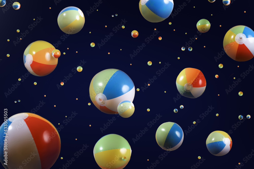 Many beach balls floating on a black background that looks like space. Many beach balls floating on a black background that looks like space.