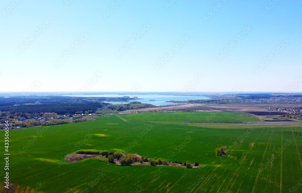 Obraz premium Aerial view of the summer landscape with green fields and meadows