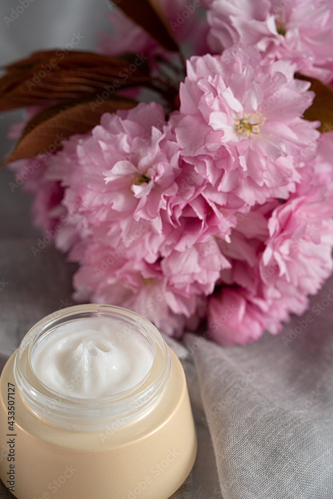 Anti wrinkle face cosmetic cream or mask with herbal flowers. Skin and body care.Beautiful pink flowers background. Anti wrinkle face cosmetic cream or mask with herbal flowers. Skin and body care.Beautiful pink flowers background.