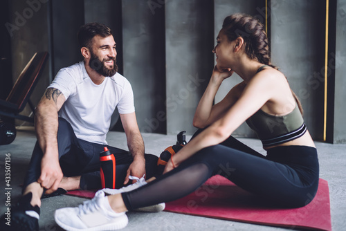 Young sporty couple resting on exercise mat