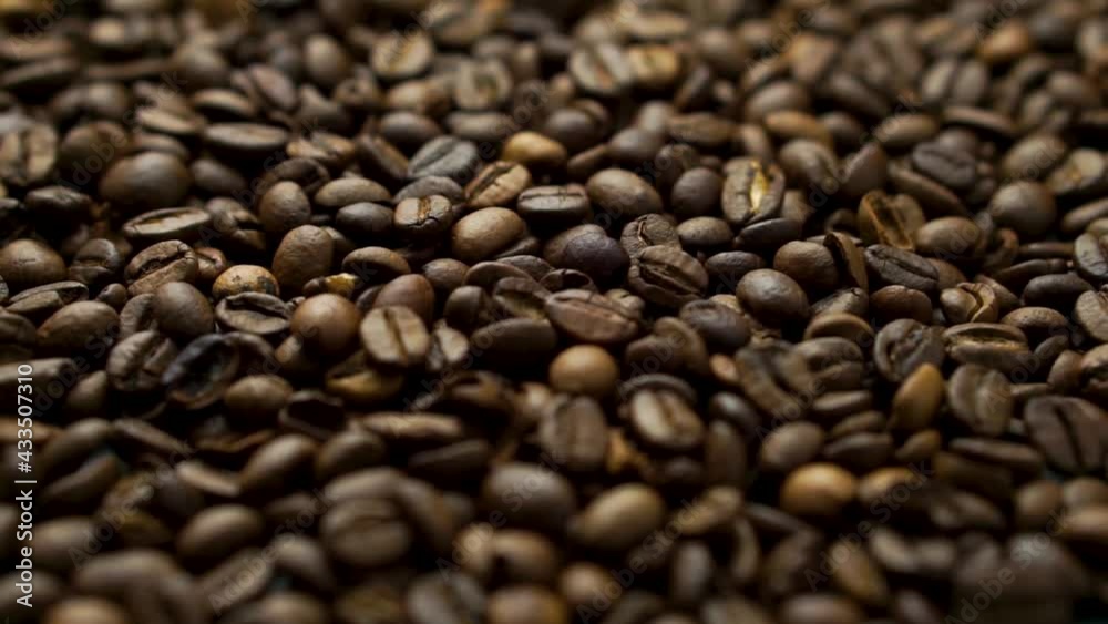 Roasted coffee beans background, flat lay, rotating slowly. Roasted coffee beans background, flat lay, rotating slowly.