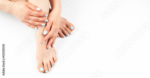 Fototapeta Naklejka Na Ścianę i Meble -  Woman feet with turquoise pedicure. Hands with manicure. On white background. Beautiful skin.