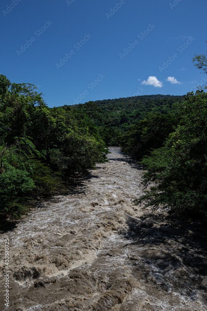 flowing river with nature and mountain background countryside flowing river with nature and mountain background countryside