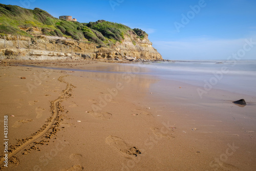Lavinio sand beach with Tor Caldara natural reserve with ancient tower on background, Anzio, Rome, Italy