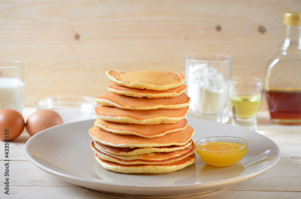pancakes with honey and ingredients for cooking on the table pancakes with honey and ingredients for cooking on the table