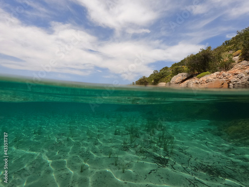 Fototapeta Naklejka Na Ścianę i Meble -  Split underwater photo of exotic Caribbean island seascape with emerald sea and beautiful clouds