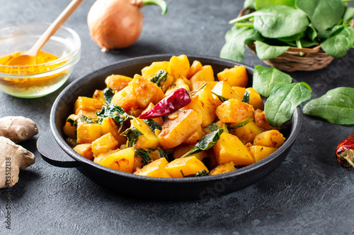 Aloo Palak sabzi or Spinach Potatoes curry served in a frying pan. Popular Indian healthy recipe