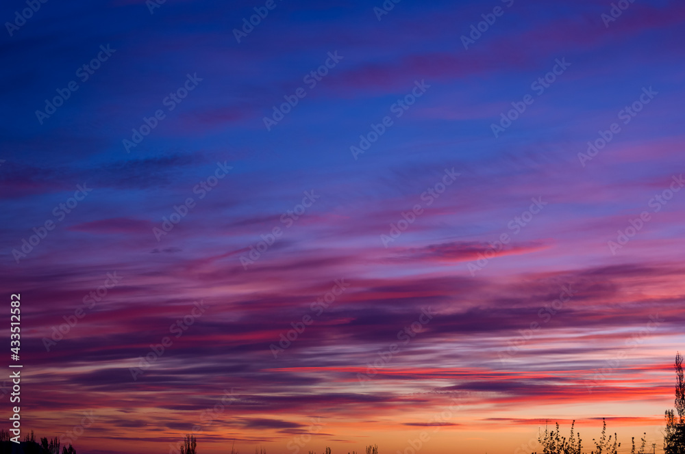 Fototapeta premium Landscape with dramatic light - beautiful golden sunset with saturated sky and clouds.