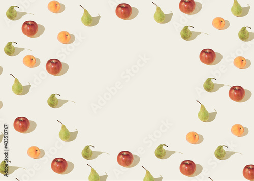 Pattern of apple pears and peaches on a light beige background. Minimal summer layout.