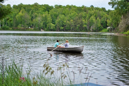 Wall Mural teen girls in a rowboat in the middle of a lake upper peninsula michigan