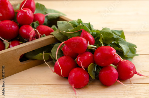 a bunch of red radishes on a wooden table