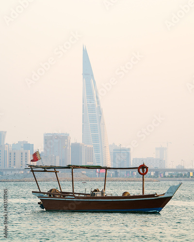 Traditional arabian dhow in the middle of the sea near Manama City.