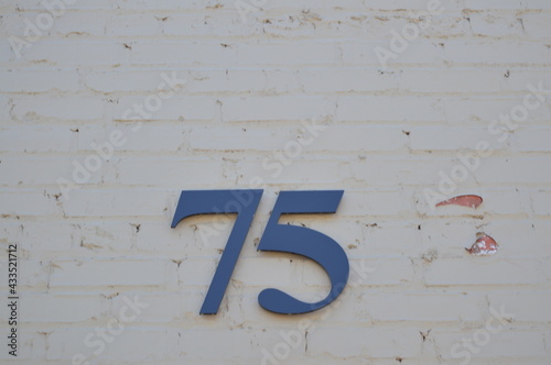 Numbers on White Brick Wall