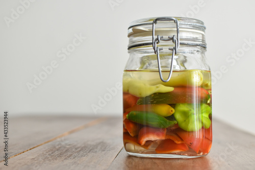 Homemade food: different kind of peppers ready to ferment in a mason jar