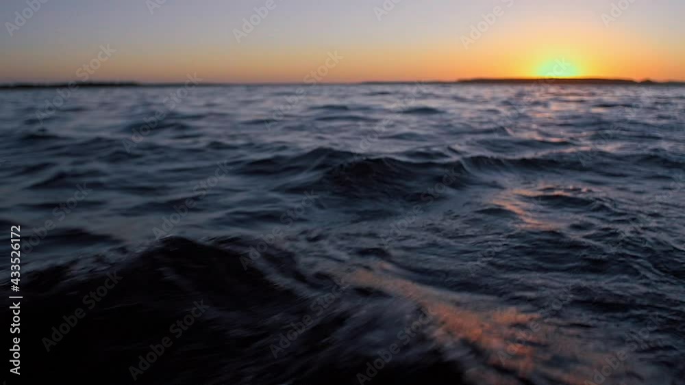 Gentle waves in slow motion with sunset in the background. Gentle waves in slow motion with sunset in the background.