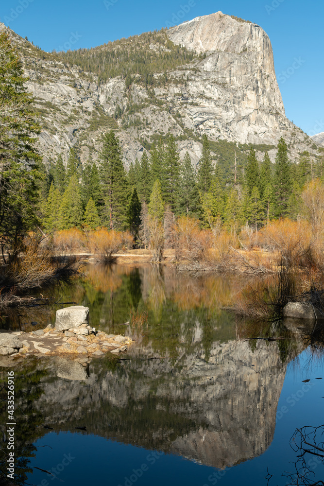 view of mirror lake and north dome on a winter day at yosemite national park in california
