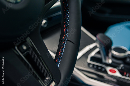Steering wheel firmware in a sports car. © Glebiy