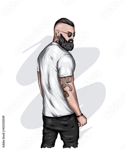 Handsome muscular guy with stylish hair, beard and tattoos. Hipster. Fashion and style, clothing and accessories.