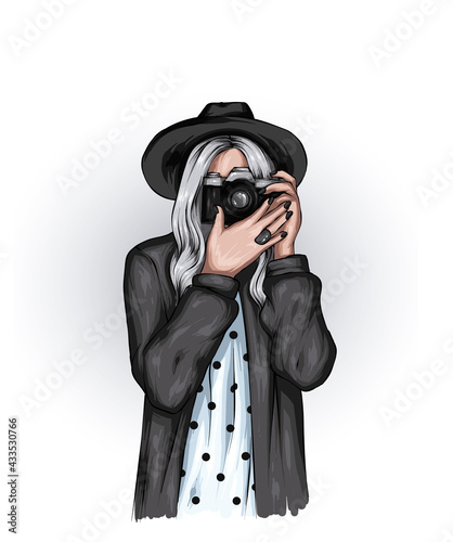 Beautiful girl in stylish clothes and with a vintage camera