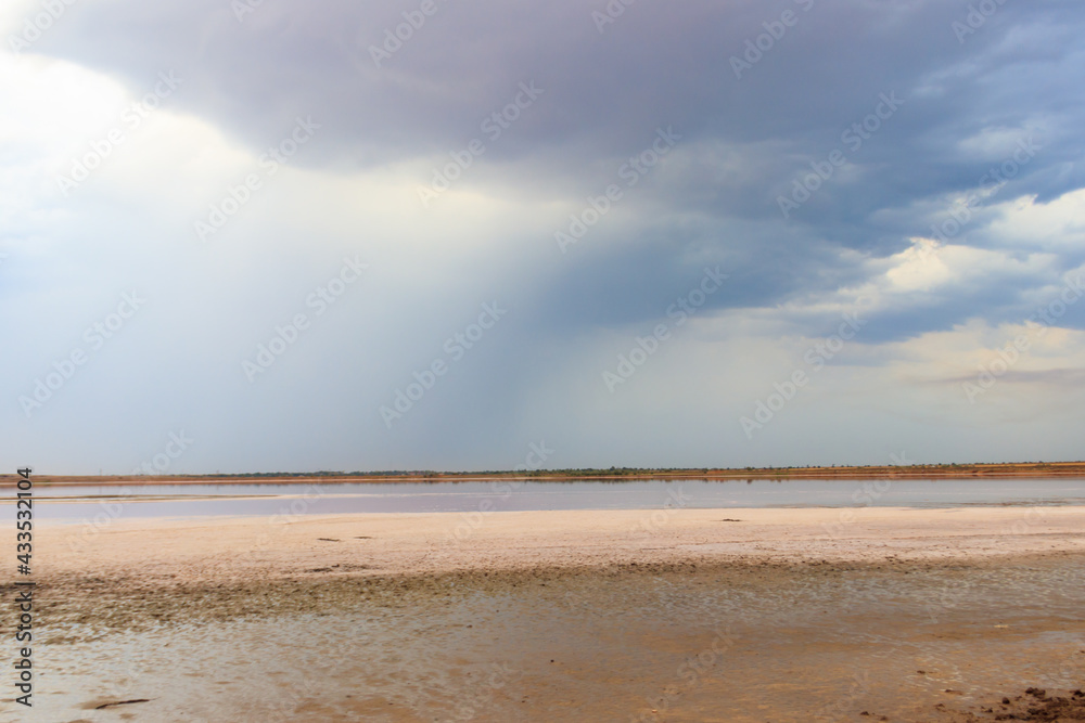 Dark storm clouds over a salt lake before a rain