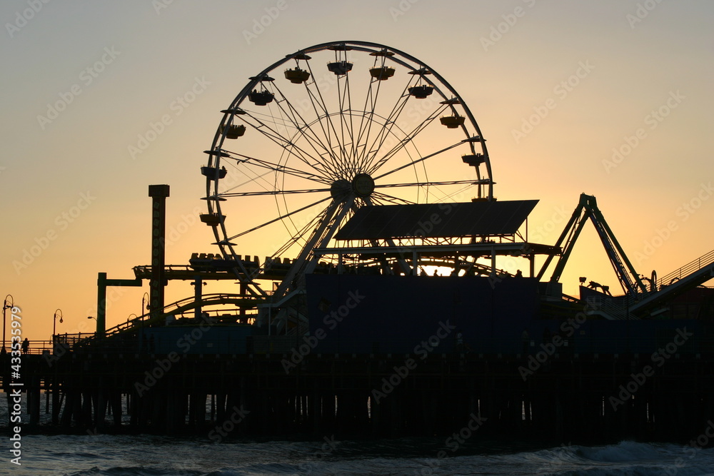 Santa Monica Ferris Wheel at Sunset in California on the Santa Monica Pleasure Pier from the Beach