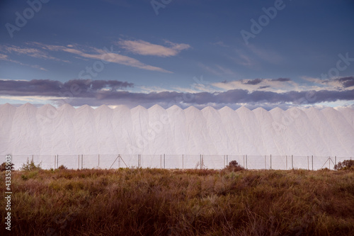 Mountains of raw salt. Storage of salt from the Salinas de Santa Pola, Alicante, Spain, where tons of sea salt are produced.