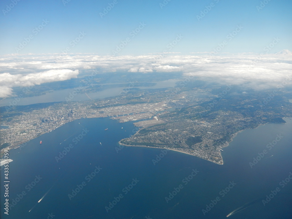 Aerial View of Seattle, Washington, Area from an Airliner showing a Peninsula with a Layer of Clouds on the Horizon