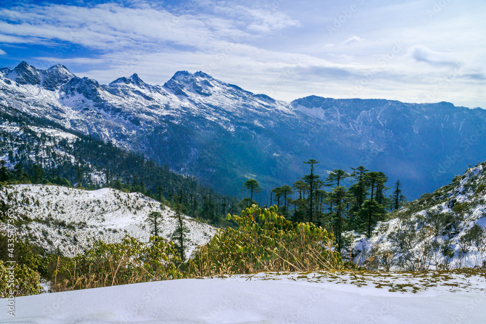 Snow-covered mountains in winter. Amazing view of snow-clad mountain landscape during Kedarkantha winter trek in Uttarkashi, Uttarakhand (India). Trek in December on Christmas and New Year.