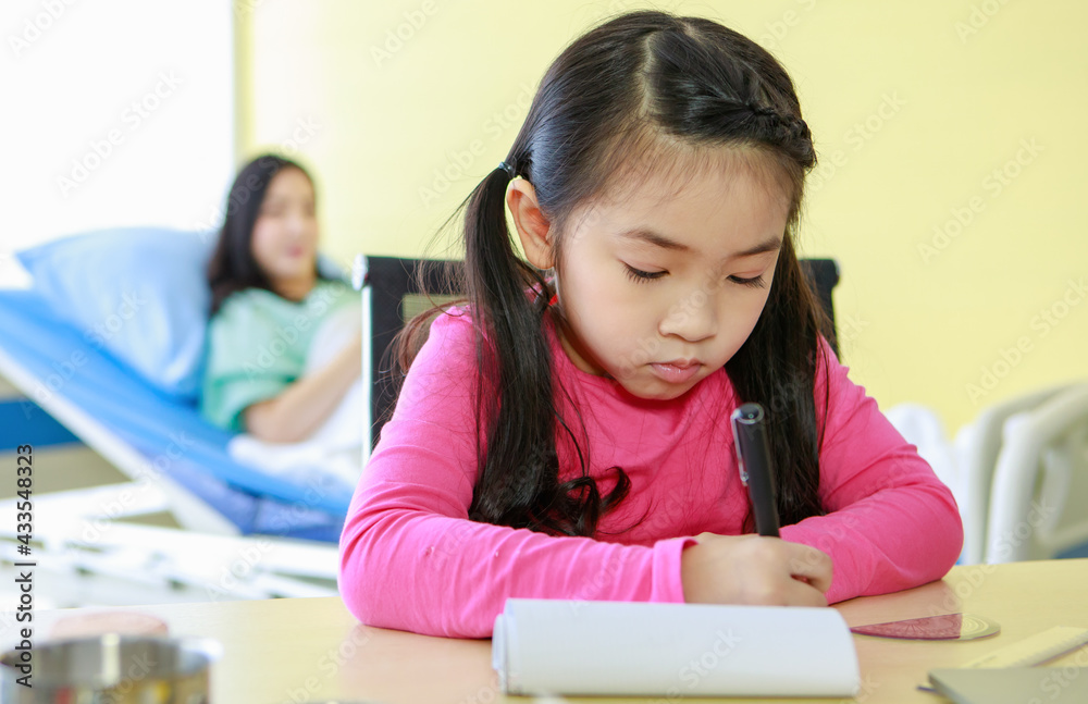 Smiling girl drawing while mother lying on hospital sofa Smiling girl drawing while mother lying on hospital sofa