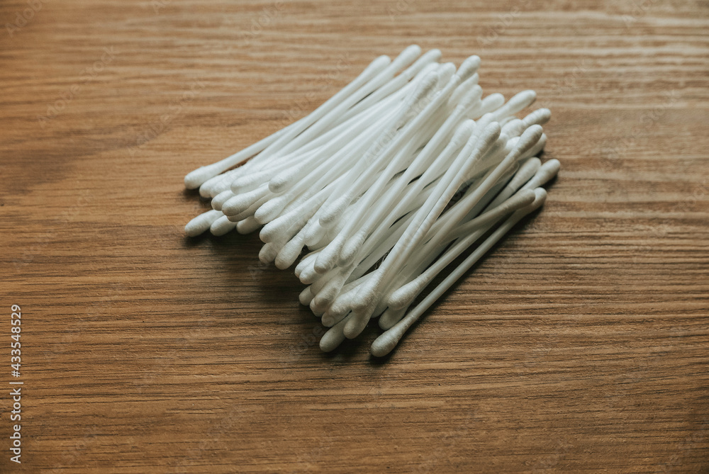White cotton buds isolated on wooden background. White cotton buds isolated on wooden background.