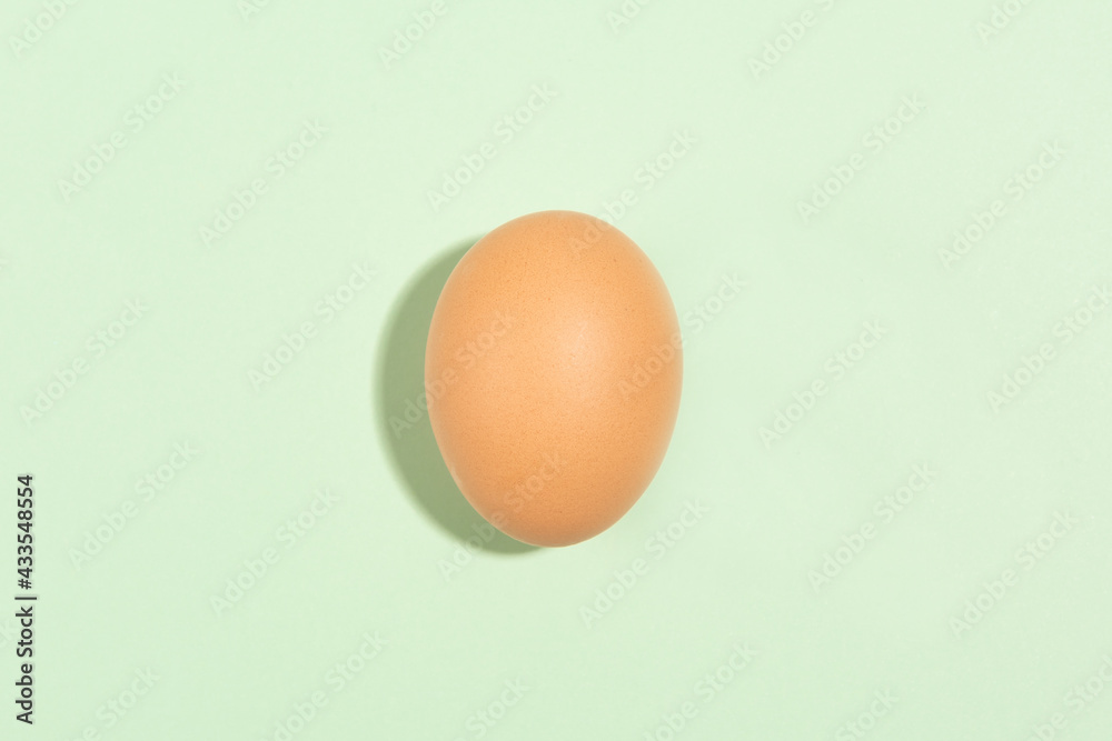 Raw brown chicken eggs on green background Raw brown chicken eggs on green background