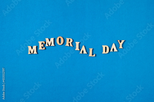 Memorial Day text made from wooden letters on blue background