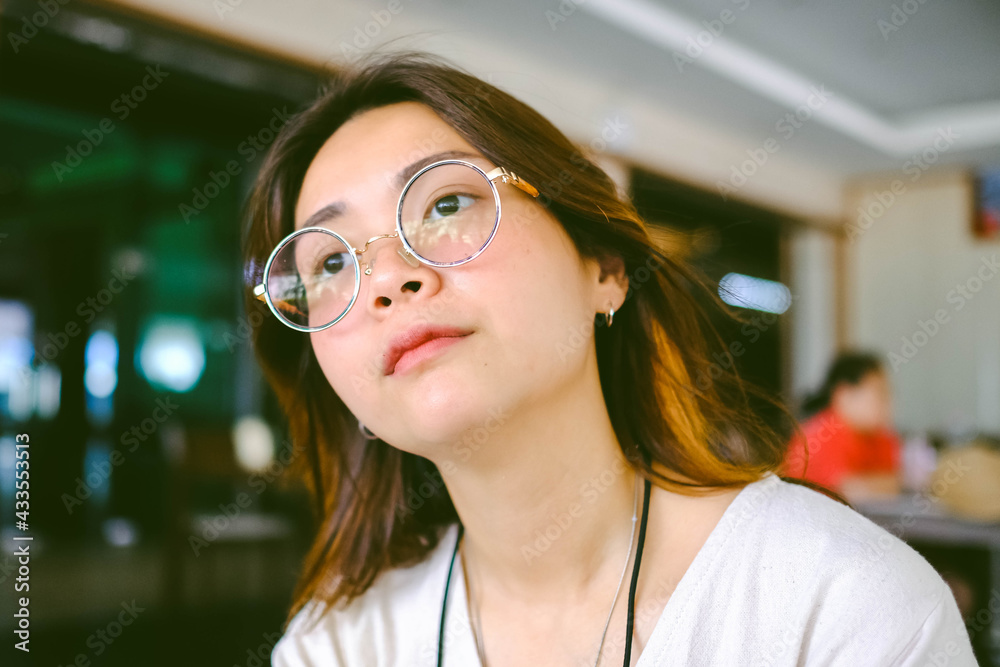 Closeup of young Asian woman wears glasses with blur background. Closeup of young Asian woman wears glasses with blur background.