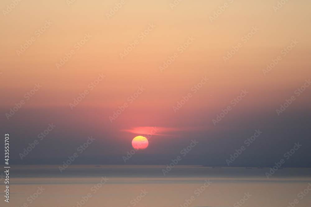 sunset view. Cloudy sky, sea and red sun sunset view. Cloudy sky, sea and red sun