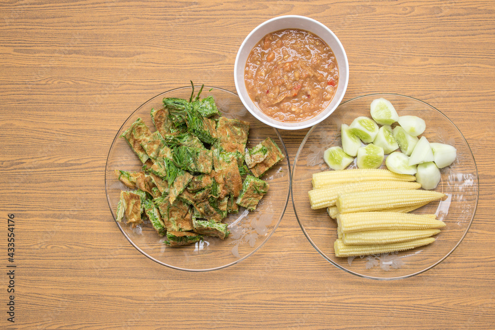 Thai food, top view of Acacia Pennata Omelette and Shrimp-paste sauce, vegetables on wooden background. Thai food, top view of Acacia Pennata Omelette and Shrimp-paste sauce, vegetables on wooden background.