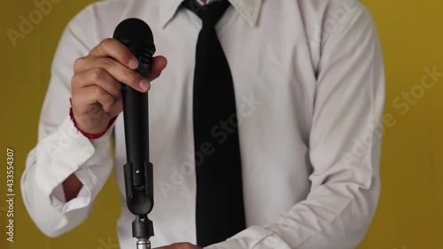 testing a microphone by tapping it with the finger, close up