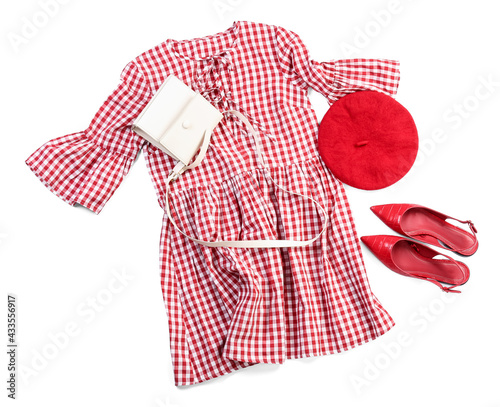 Stylish female clothes with accessories on white background