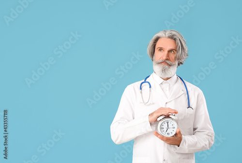 Doctor with alarm clock on ...