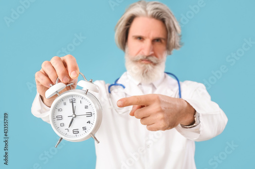Doctor pointing at alarm cl...