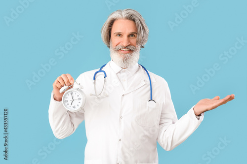 Doctor with alarm clock sho...