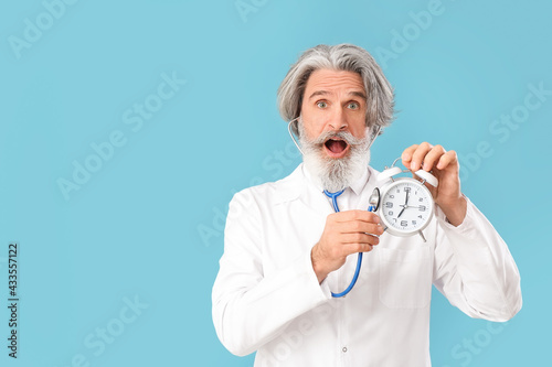 Doctor with alarm clock and...