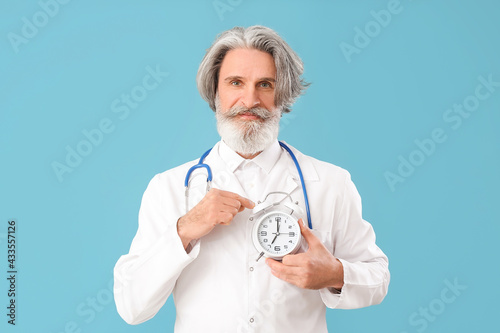 Doctor with alarm clock on ...