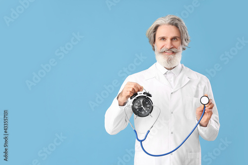 Doctor with alarm clock and...