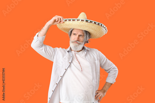 Senior man in sombrero hat ...