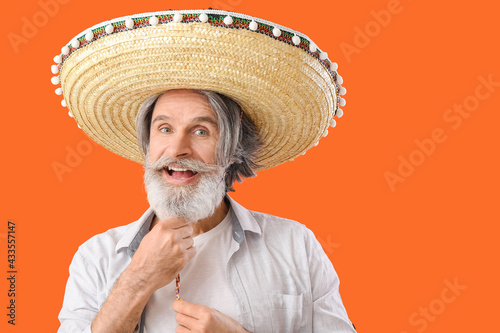 Happy senior man in sombrer...