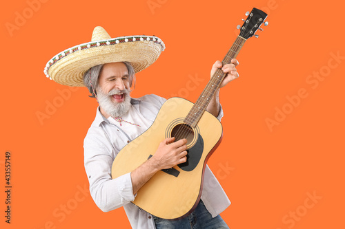 Senior man in sombrero hat ...