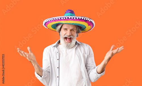 Excited senior man in sombr...